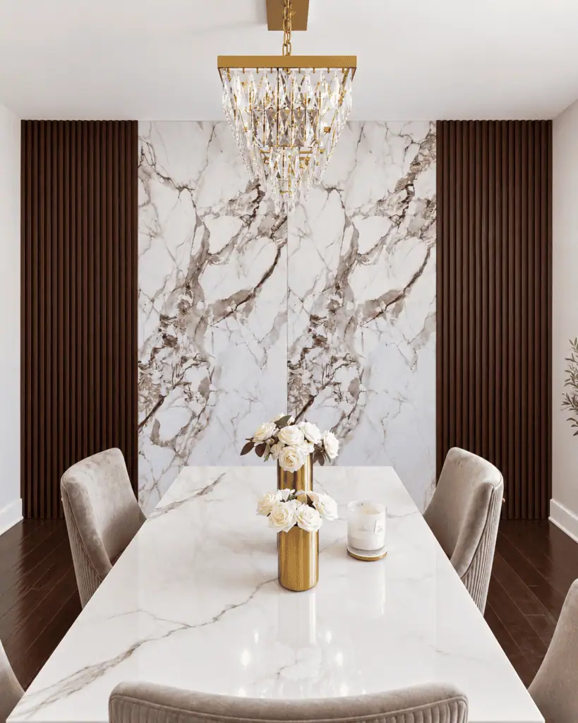 Modern dining room with marble wall and chandelier lighting.